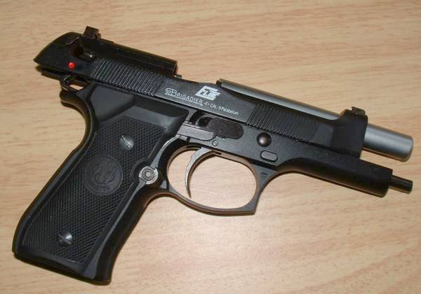 Realistic looking, but fake, trademarks - Grips on this gun are real steel Beretta - Note left handed mag release.