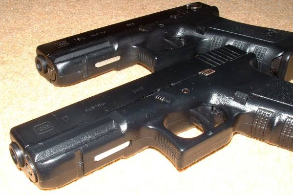 Rail and serial number plate visible on both Glocks.